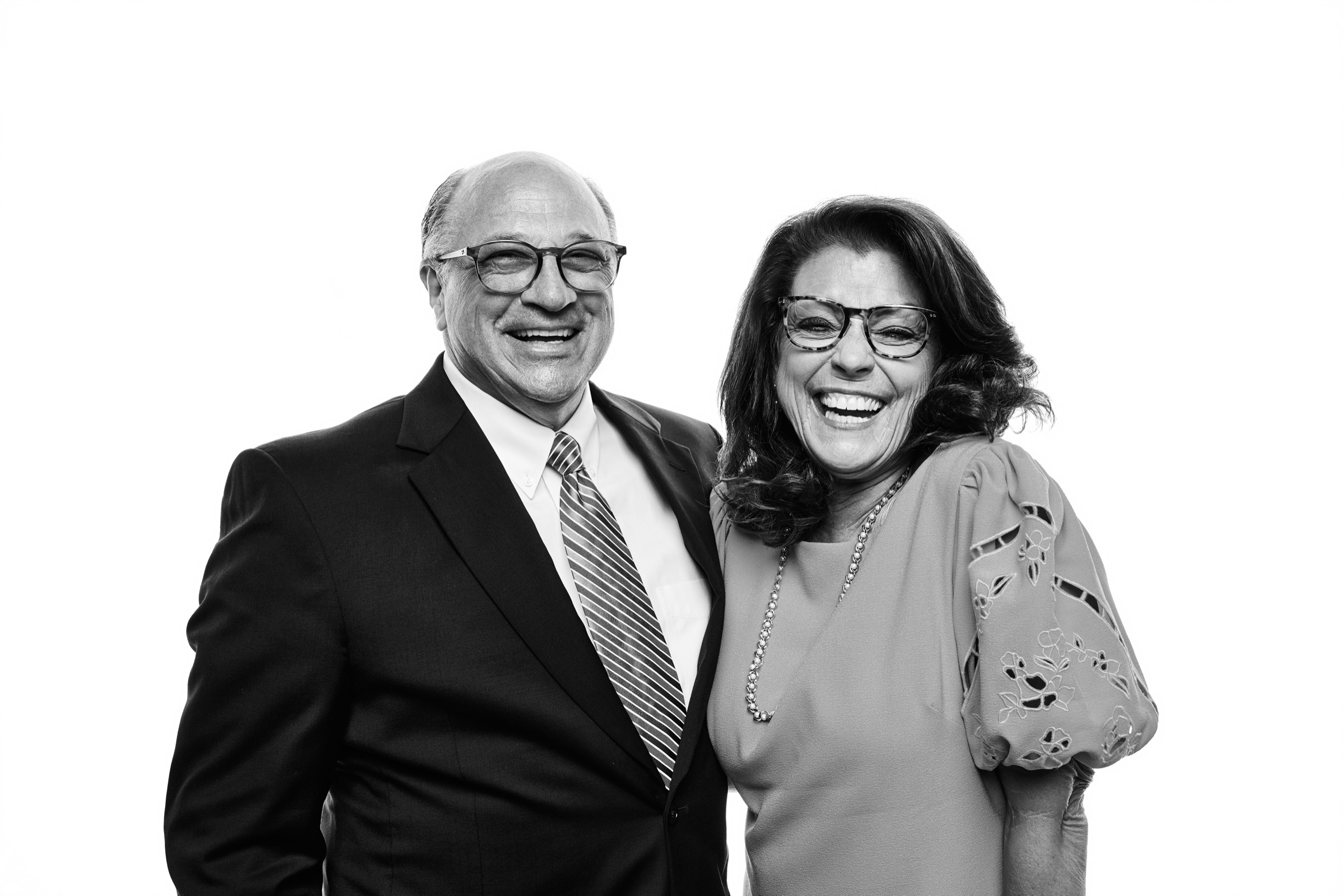 A couple laughing with delight during their portrait session