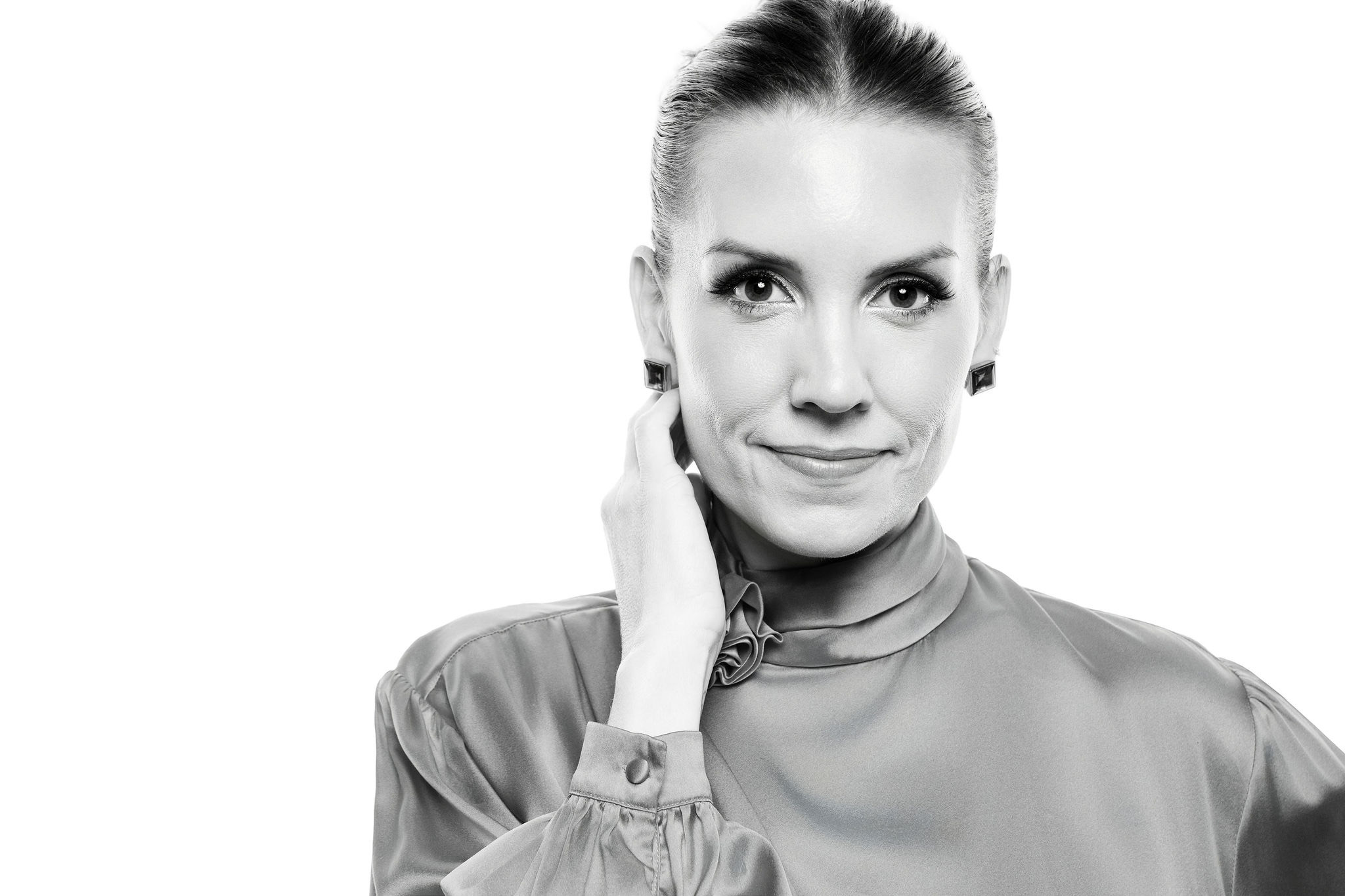 A guest photographed in profile under studio lighting against the signature white backdrop